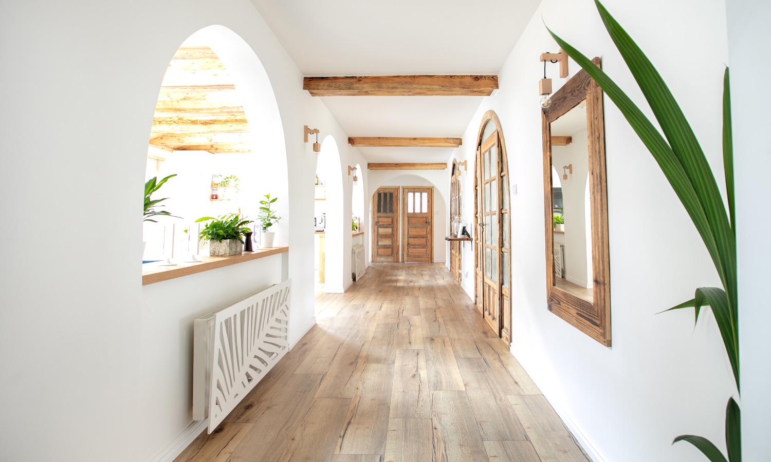 Bright, modern hallway with wood beams and large mirrors, exemplifying Bayside Builders Group’s expertise in stylish home remodeling in the Bay Area.