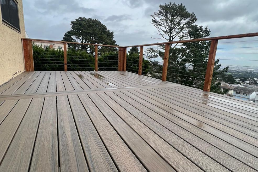A newly built wooden deck overlooking a scenic view in the Bay Area, showcasing craftsmanship in outdoor home improvement by Bayside Builders Group.